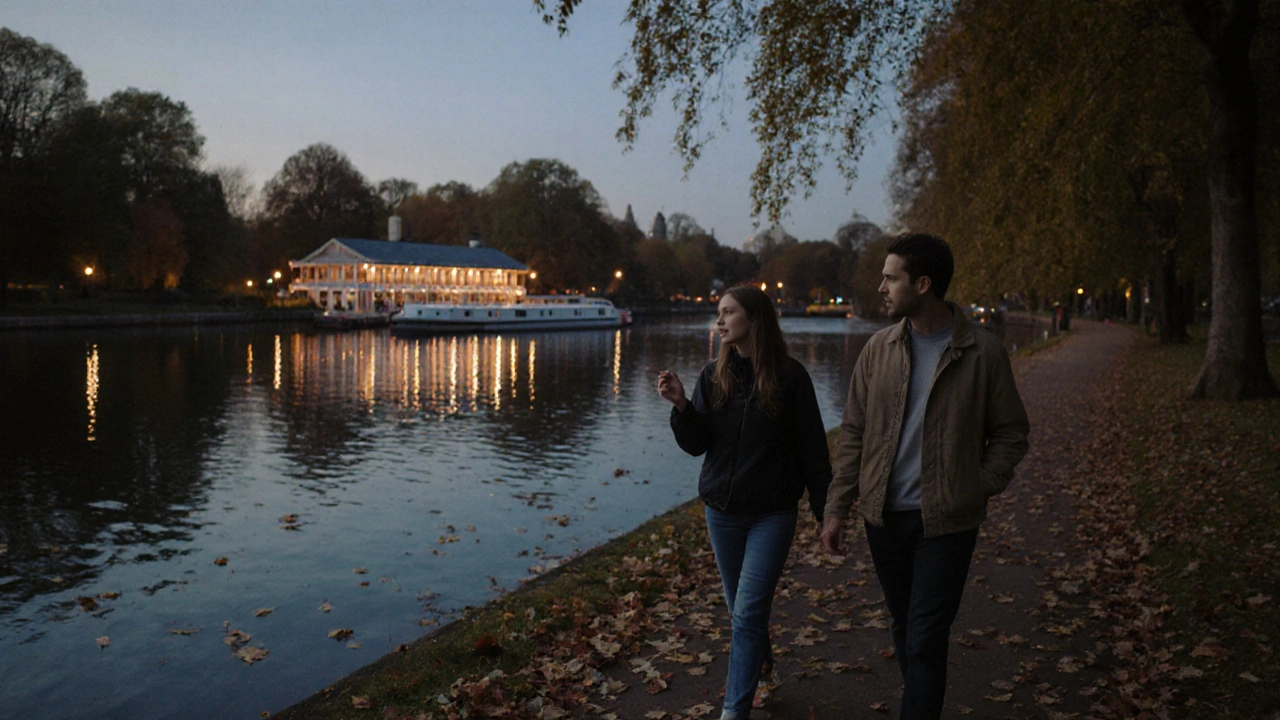 Two people walking peacefully together along the Serpentine in Hyde Park at sunset.