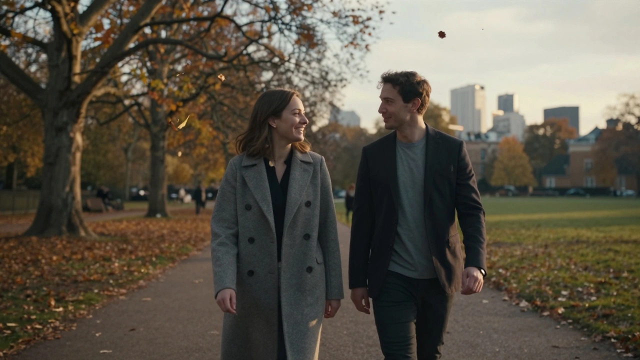 A couple walking peacefully side by side along Hyde Park at sunset, engaged in quiet conversation.