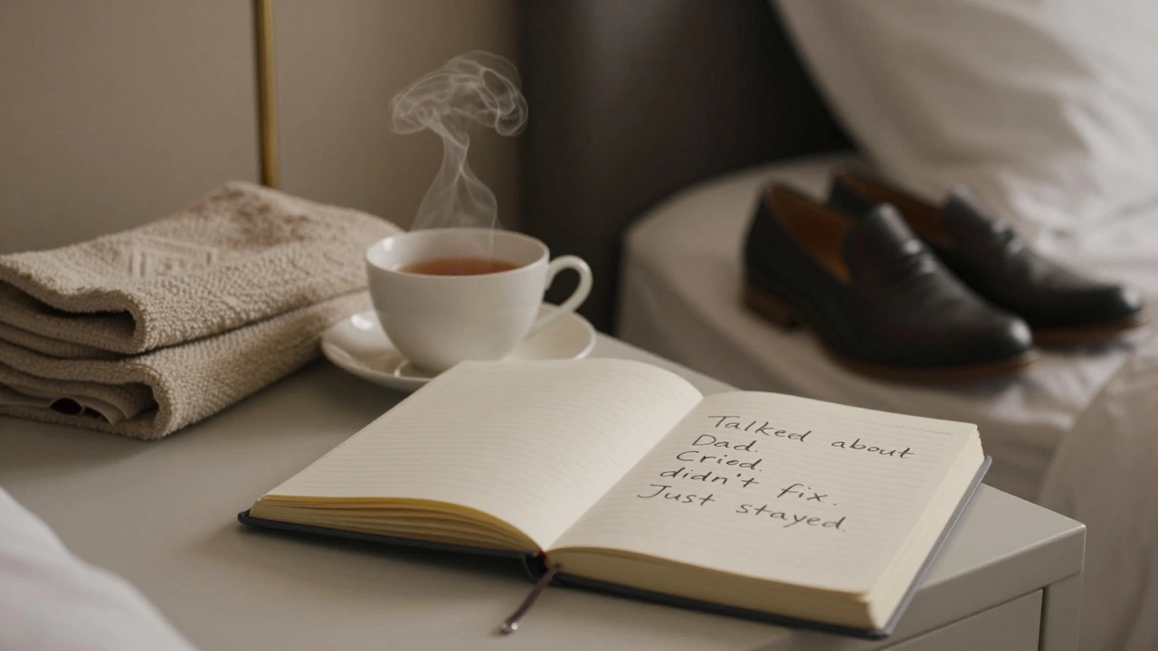 A handwritten note on a bedside table in a London hotel room, reading 'Just stayed,' with a cooling tea cup.