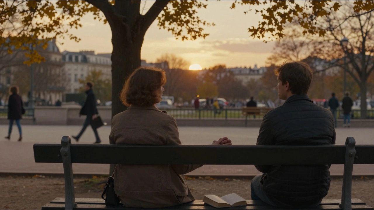 A woman and escort hold hands on a park bench, watching the sunset, a book open on her lap.